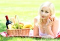 Picnic. Blonde young woman with basket of food