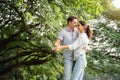 Picnic and Camping time. Young couple having fun in the moment of love in the park. Love and tenderness, Romantic man playing Royalty Free Stock Photo