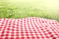 Picnic cloth on green grass background empty space
