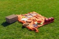 Picnic items on a green, well-groomed lawn