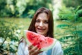 Picnic in nature and healthy eating. A sexy girl in the woods eats watermelon Royalty Free Stock Photo