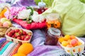 Picnic in the outdoor with strawberry, apricots, oranges, apples Royalty Free Stock Photo