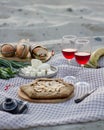 Picnic on the sandy beach with Apple pie and red wine in glasses. Royalty Free Stock Photo