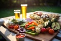 picnic scene with pilsner beer and array of grilled veggies Royalty Free Stock Photo