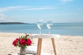 Picnic by the sea with flowers and a glass of champagne