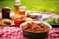 picnic setting with a bowl of bourbon bbq pulled chicken