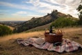 picnic setup with basket, blanket, and bottle of wine on grassy hilltop