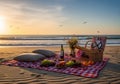 Picnic setup on a sandy beach at sunset. A red and white Royalty Free Stock Photo