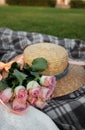 Picnic. Straw hat and flowers on the lawn