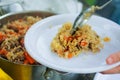 A picnic in the summer on the nature.in a saucepan of delicious lamb pilaf. laid out on the plate portion