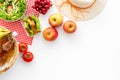 Picnic in summer with products, sandwich, salad, fruits, drinks and hat on white background top view space for text