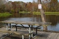 Picnic table with alligator warning sign