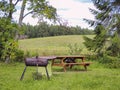 Picnic table and BBQ pit at a forest campsite in Oregon Royalty Free Stock Photo