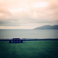 Picnic Table Benches and cloudy seascape in Waterville, County Kerry.