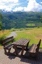 Picnic table and benches near lake. Royalty Free Stock Photo