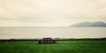 Picnic Table Benches and seascape in Waterville, County Kerry - vintage effect.