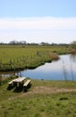 Picnic table, benches, small lake in countryside