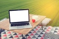 Picnic table with blank screen on laptop and white coffee cup, r Royalty Free Stock Photo
