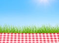 A Picnic table covered with checkered tablecloth Royalty Free Stock Photo