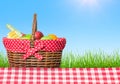 A picnic table covered with checkered tablecloth