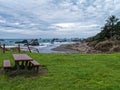 A picnic table on a grassy patch above the shore at Harris Beach State Park in Oregon, USA Royalty Free Stock Photo