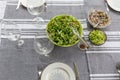 A picnic table with a large bowl of tossed garden salad and plates