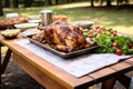 picnic table loaded with alabama chicken for a family outing