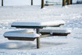 A picnic table in the park covered in snow. Royalty Free Stock Photo