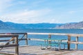 Picnic table on pier in Naramata with scenic view of Okanagan Lake and mountains Royalty Free Stock Photo