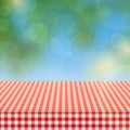 Picnic table with red checkered pattern of linen tablecloth and blurred nature background vector illustration