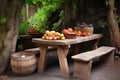 picnic table with a rustic, hand-carved bench and basket of fresh fruit