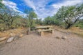 Picnic table on a sandy ground with large stones in Tucson, Arizona Royalty Free Stock Photo