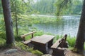 Picnic table seating in forest near lake Royalty Free Stock Photo