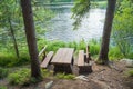 Picnic table seating in forest near lake Royalty Free Stock Photo