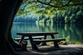 A picnic table by a serene lake Royalty Free Stock Photo