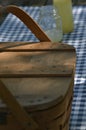Picnic table with vintage picnic basket, blue checked table cloth Royalty Free Stock Photo