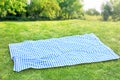 Picnic tablecloth on grass outdoor meal background.Food advertisement design backdrop empty space.Checkered cloth Royalty Free Stock Photo