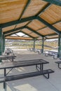 Picnic tables with benches inside a pavilion Royalty Free Stock Photo
