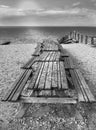 Picnic tables with benches on Whitstable beach in monochrome Royalty Free Stock Photo