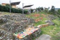 Picnic tables made of pieces of brightly colored ceramic tiles built next to the bathing area or the natural pool