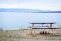 Picnic tables near mountain lake at the lake side in fall season Royalty Free Stock Photo