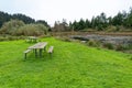 Picnic tables by a pond at the Arizona Beach State Recreation Site, Oregon, USA Royalty Free Stock Photo