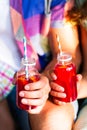 Picnic theme: happy young family holding drinks, toast bottle w