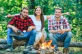 Picnic time. Friends camping concept. Tourists relaxing. Company friends enjoy relaxing together in forest. They are Royalty Free Stock Photo