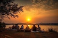 picnic with view of the sunset, people enjoying a moment of tranquility and beauty