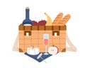 Picnic wicker basket with bottle of wine and food. Hamper with snacks, fruits, baguettes, cheese and alcoholic drink for