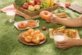 Picnic wicker basket with food, bread, fruit and orange juice on Royalty Free Stock Photo