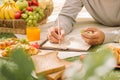 Picnic wicker basket with food, bread, fruit and orange juice on Royalty Free Stock Photo