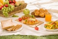 Picnic wicker basket with food, bread, fruit and orange juice on Royalty Free Stock Photo