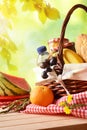 Picnic wicker basket with food on table in field vertical Royalty Free Stock Photo